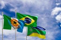 Official flags of the country Brazil, state of Amapa and city of Santana. Swaying in the wind under the blue sky. 3d rendering