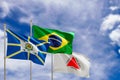 Official flags of the country Brazil, state of Minas Gerais and city of Araguari. Swaying in the wind under the blue sky. 3d