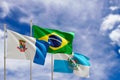 Official flags of the country Brazil, state of Rio de Janeiro and city of Niteroi. Swaying in the wind under the blue sky. 3d