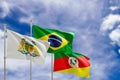 Official flags of the country Brazil, state of Rio Grande do Sul and city of Caixias do Sul. Swaying in the wind under the blue