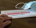 Official legal eviction order or notice to renter or tenant of home with face mask