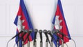 Cambodian official press conference. Flags of Cambodia and microphones. Conceptual 3D rendering