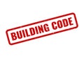 Official red distressed rubber stamp clearly indicating important building code compliance Royalty Free Stock Photo