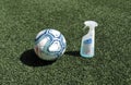 The official soccer ball of the Spanish soccer league next to a virucidal spray against the coronavirus covid-19 on soccer field