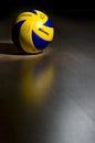 Official volleyball on hardwood floor Royalty Free Stock Photo