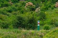 Official warning pole about the border zone of the Republic of Moldova with the state emblem on the plate. Background