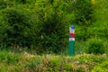 Official warning pole about the border zone of the Republic of Moldova with the state emblem on the plate. Background