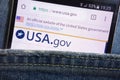 Official website of the United States government displayed on smartphone hidden in jeans pocket