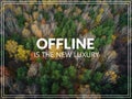 Offline is the new luxury. Aerial view of the forrest with different color trees.