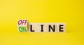 Offline and online symbol. Tturned wooden cubes with words Online and Offline. Beautiful yellow background. Business concept. Copy