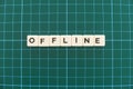 Offline word made of square letter word on green square mat background