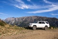 Offroad car on mountains background. Off-road travel concept background. Summer vacation. Royalty Free Stock Photo