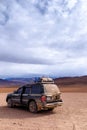 Offroad car parked in a desert Royalty Free Stock Photo