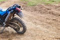 Offroad mountain motorcycle or bike taking part in motocros competition parked on dirty terrain road