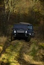 Offroad race in autumn forest. SUV or two black offroad cars on fall nature background. Car racing extreme and four Royalty Free Stock Photo