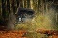 Offroad race on fall nature background. Car racing in autumn forest. Extreme, challenge and 4x4 vehicle concept. SUV or Royalty Free Stock Photo