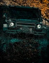 Offroad vehicle goes on mountain way. Off-road vehicle goes on the mountain. Mudding is off-roading through an area of