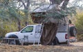 Offroad 4x4 vehicle with tent in the roof, monkey on the roof Royalty Free Stock Photo