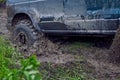 Offroader stalled in the mud during an off-road race, wheels slip on slush Royalty Free Stock Photo