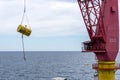 An offshore crane lifting an anchor buoy while performing anchor handling activities at offshore oilfield