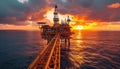 Offshore drilling rig in ocean at sunset, with boat on water Royalty Free Stock Photo