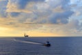 Offshore jack up drilling rig and supply boat Royalty Free Stock Photo