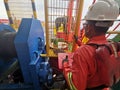 Offshore marine crew operate tugger winch during anchor handling operation at sea