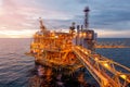 Offshore oil and gas rig platform with beautiful sky in sunset time for business industry concept Royalty Free Stock Photo