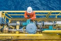 Offshore oil rig worker checking parameter of coriolis digital flow transmitter meter, instrument and electrical service. Royalty Free Stock Photo