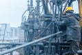 Offshore oil rig worker prepare tool and equipment for perforation oil and gas well at wellhead platform. Making up a Royalty Free Stock Photo