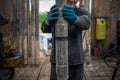 Offshore oil rig worker prepare tool and equipment for perforation oil and gas well at wellhead platform. Making up a drill pipe