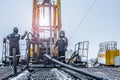 Offshore oil rig worker prepare tool and equipment for perforation oil and gas well at wellhead platform. Making up a drill pipe