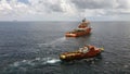 Offshore supply vessel and offshore crew boat on an oil field, cargo operations undergo