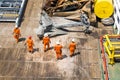 A team of rigger lifting an anchor from a construction work barge