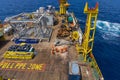 A team of rigger lifting an anchor from a construction work barge