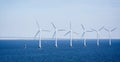 Offshore wind farm in the Baltic Sea off the coast of Copenhagen, Denmark with the Oresund Bridge in the background Royalty Free Stock Photo