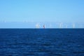 An offshore wind farm and a lighthouse in the North Sea in Germany Royalty Free Stock Photo