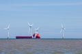 Offshore wind farm turbines with maintenance with supply ship Royalty Free Stock Photo