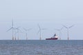 Offshore wind farm turbines with maintenance supply vessel ship Royalty Free Stock Photo