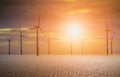 Offshore Wind Turbine in a Wind farm under construction off coast of England at sunset. Royalty Free Stock Photo