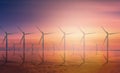 Offshore Wind Turbine in a Wind farm under construction off coast at sunset. Royalty Free Stock Photo