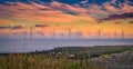 Offshore Wind Turbine in a Windfarm under construction off the England Coast at sunset Royalty Free Stock Photo