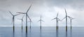 Offshore wind turbines farm on the ocean. Sustainable energy Royalty Free Stock Photo