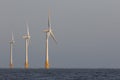 Offshore wind turbines. Windfarm on the sea horizon. Clean energy. Royalty Free Stock Photo