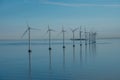 Offshore windmill park alternative energy. windmills in the sea with reflection in the morning, denmark