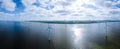 offshore windmill park with clouds and a blue sky, windmill park in the ocean drone aerial view with wind turbine