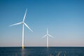 Offshore windmill park green energy in the Netherlands Europe, wind mill turbines at sea and land providing green energy Royalty Free Stock Photo