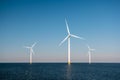 Offshore windmill park green energy in the Netherlands Europe, wind mill turbines at sea and land providing green energy