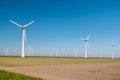 Offshore windmill park green energy in the Netherlands Europe, wind mill turbines at sea and land providing green energy Royalty Free Stock Photo