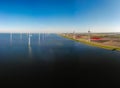 Offshore windmill park green energy in the Netherlands Europe, wind mill turbines at sea and land providing green energy Royalty Free Stock Photo